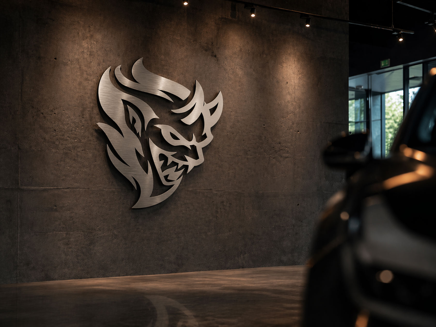 Brushed-metal Diablo AI demon mark on a dealership concrete wall beside a dark luxury vehicle